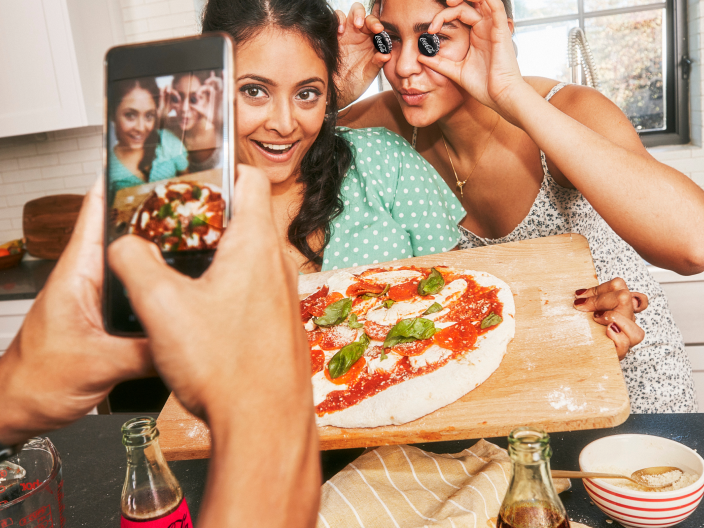 Taking a picture with pizza