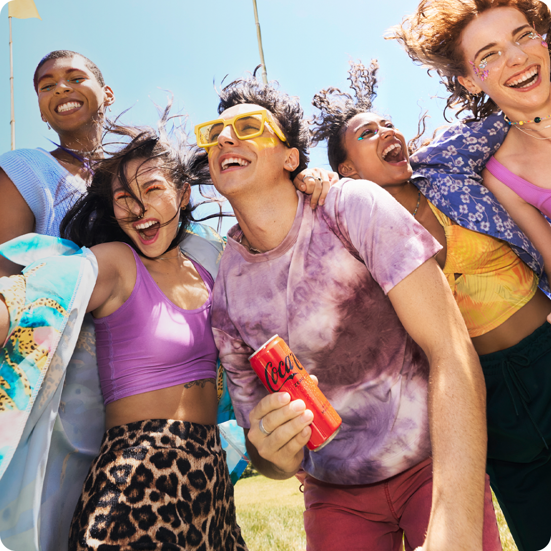 Group of people enjoying a misic festival drinking coca cola