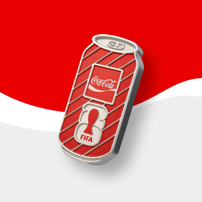 Silver Coca-Cola & FIFA collectible badge on red and gray background. 
