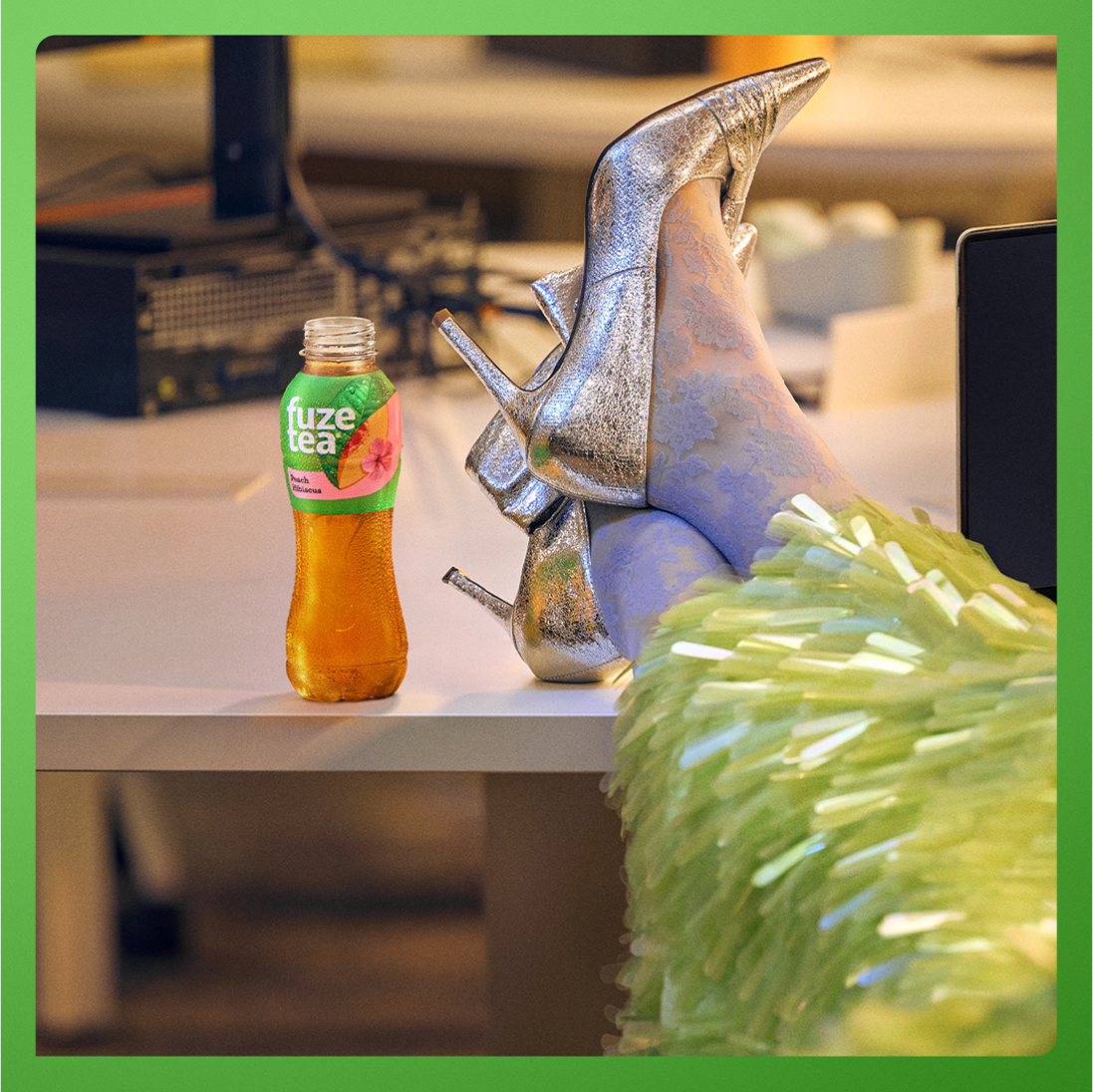 Putting high-heeled feet up next to bottle of fuze tea
