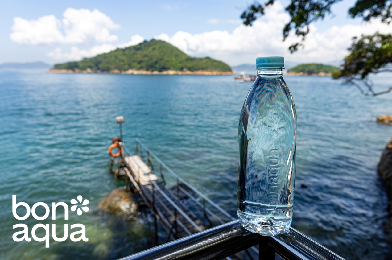 Bon aqua bottle placed in front of a natural landscape