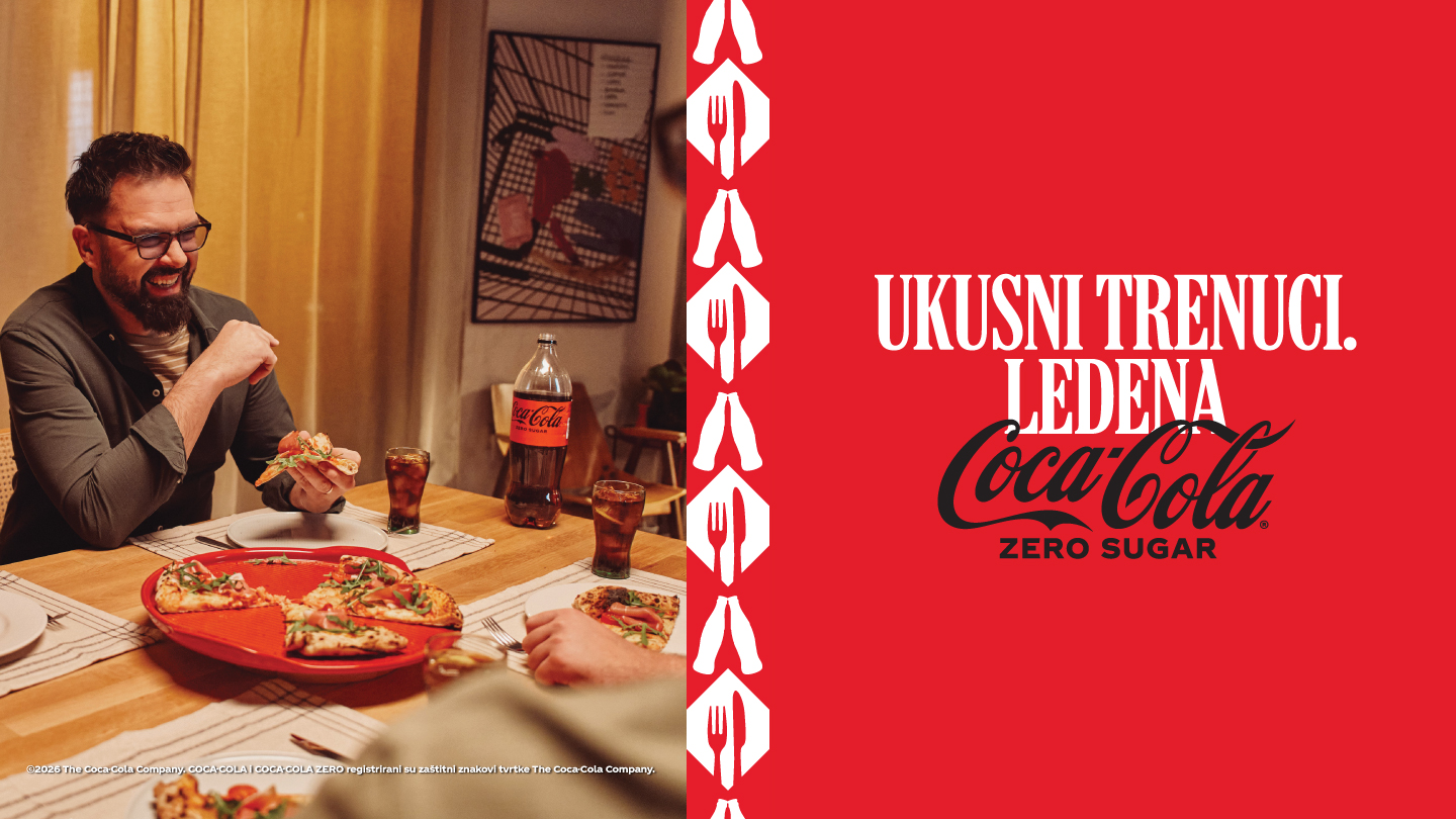 Petar Grašo sjedi za stolom uz pizzu i Coca-Colu Zero Sugar.