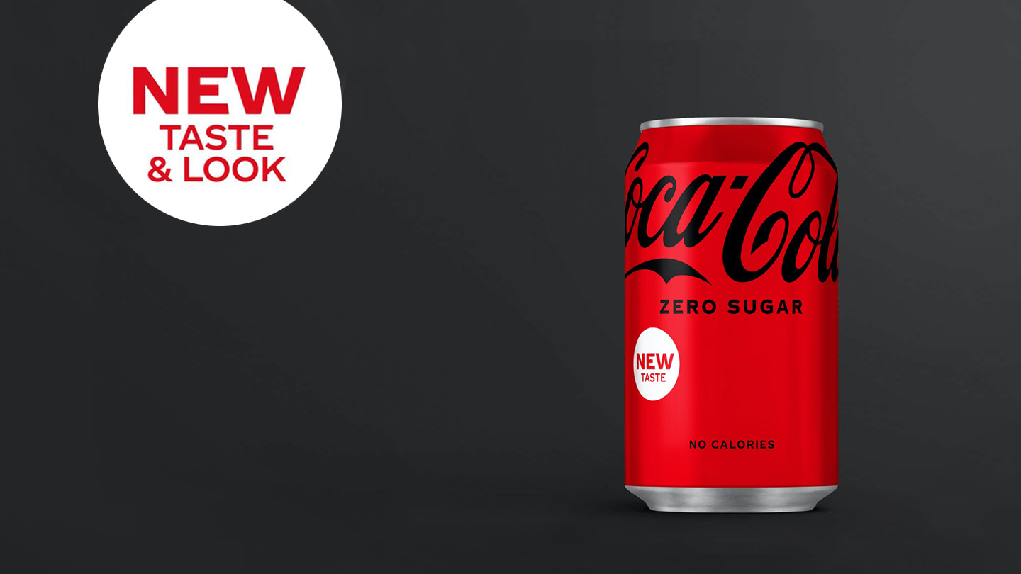 Coca-Cola Zero Sugar can on dark grey background with the phrase 'new taste & look' written on the side