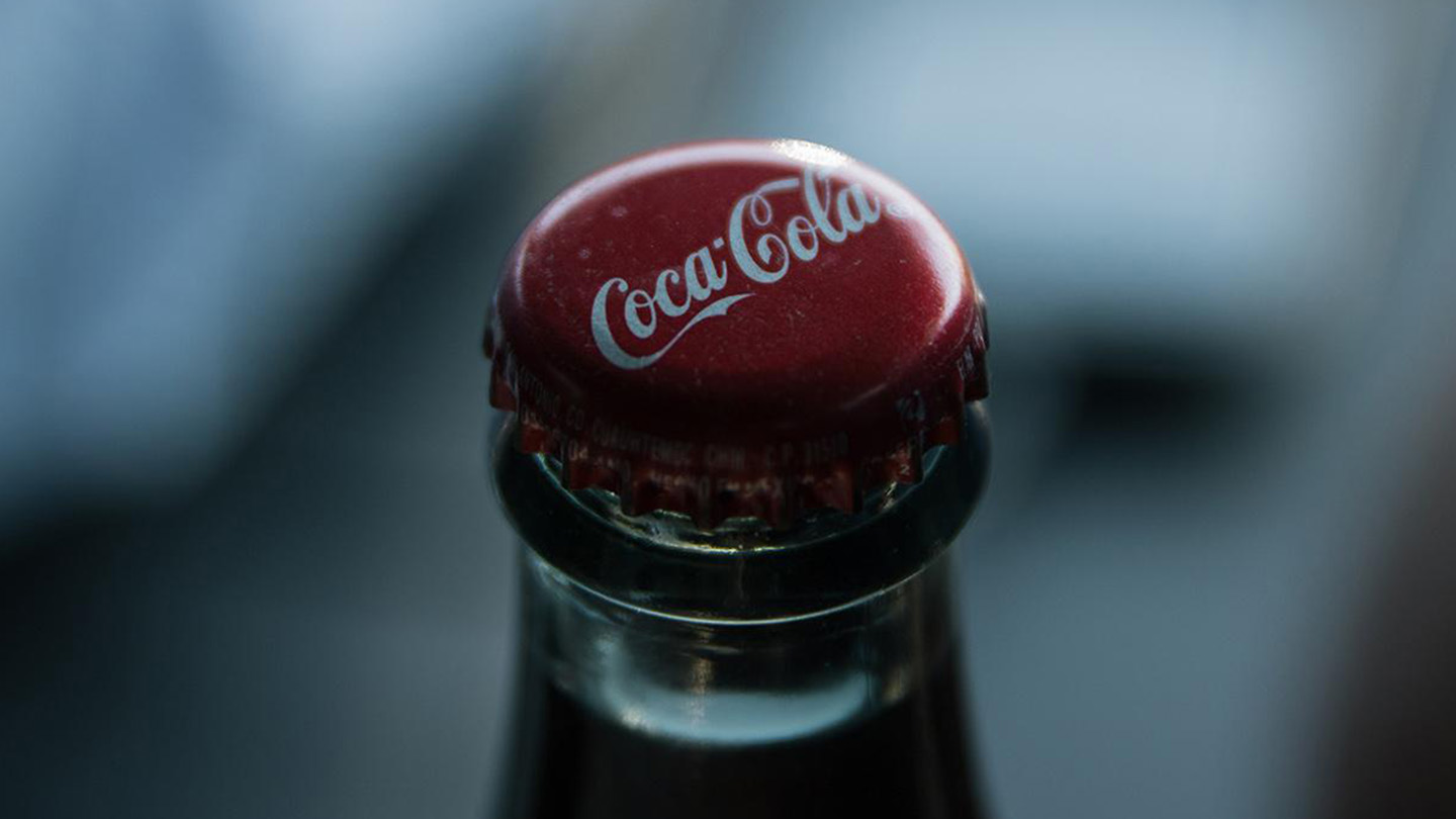 Detail of the lid of a glass bottle of Coca-Cola with a blurry background