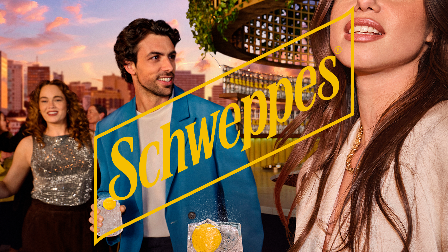 people outside holding a glass and schweppes logo