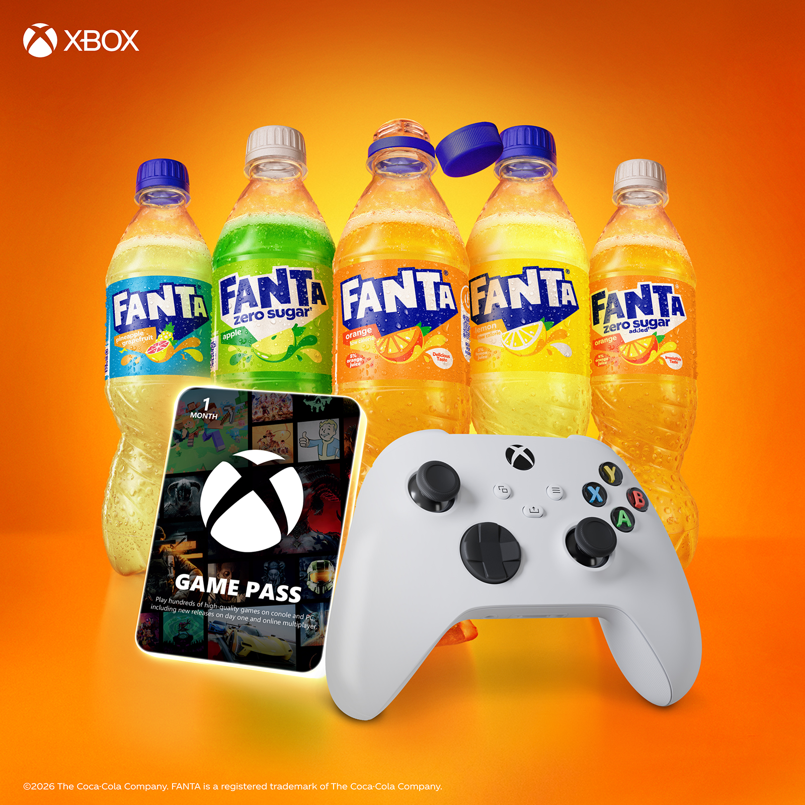 Fanta bottles, Xbox game pass and Xbox controller on orange background