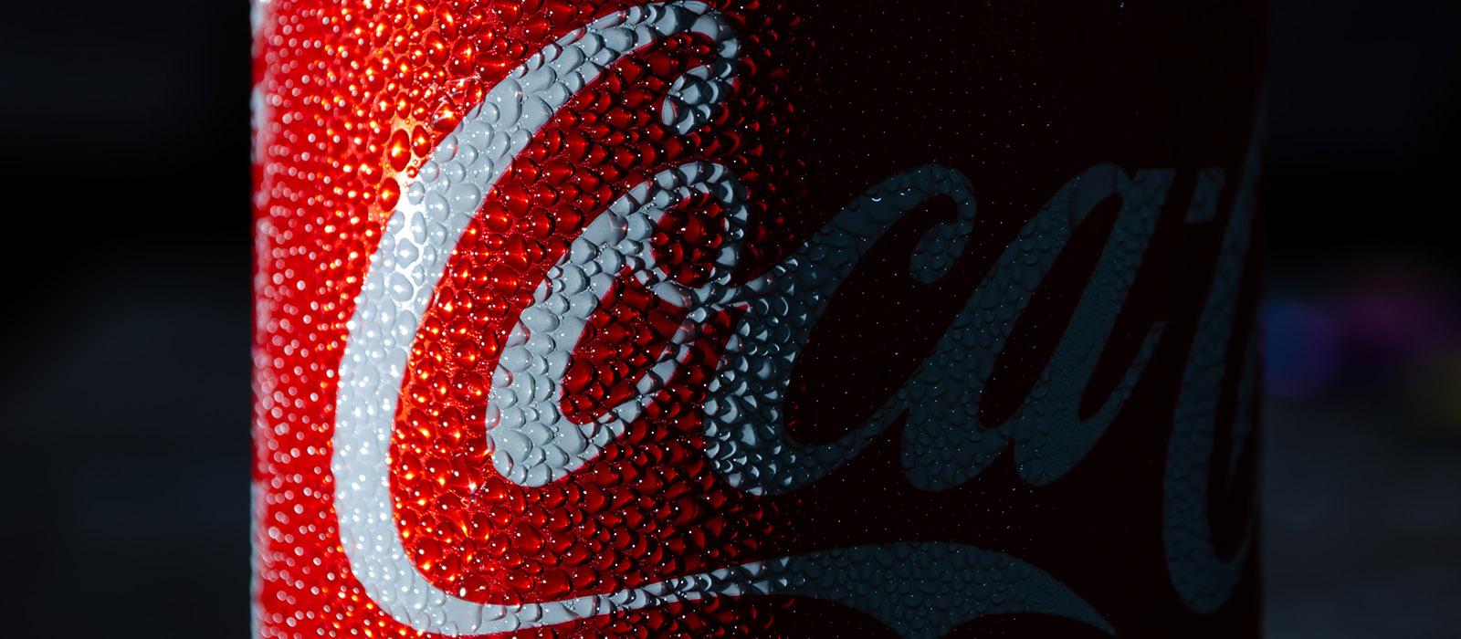 Detail of small droplets outside a Coca-Cola can on a dark background