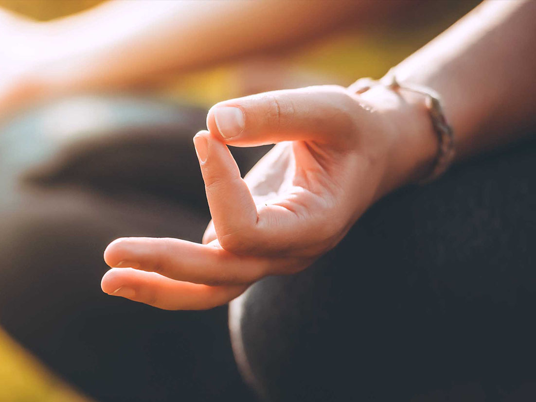 Detail of a hand of a person in meditation position 
