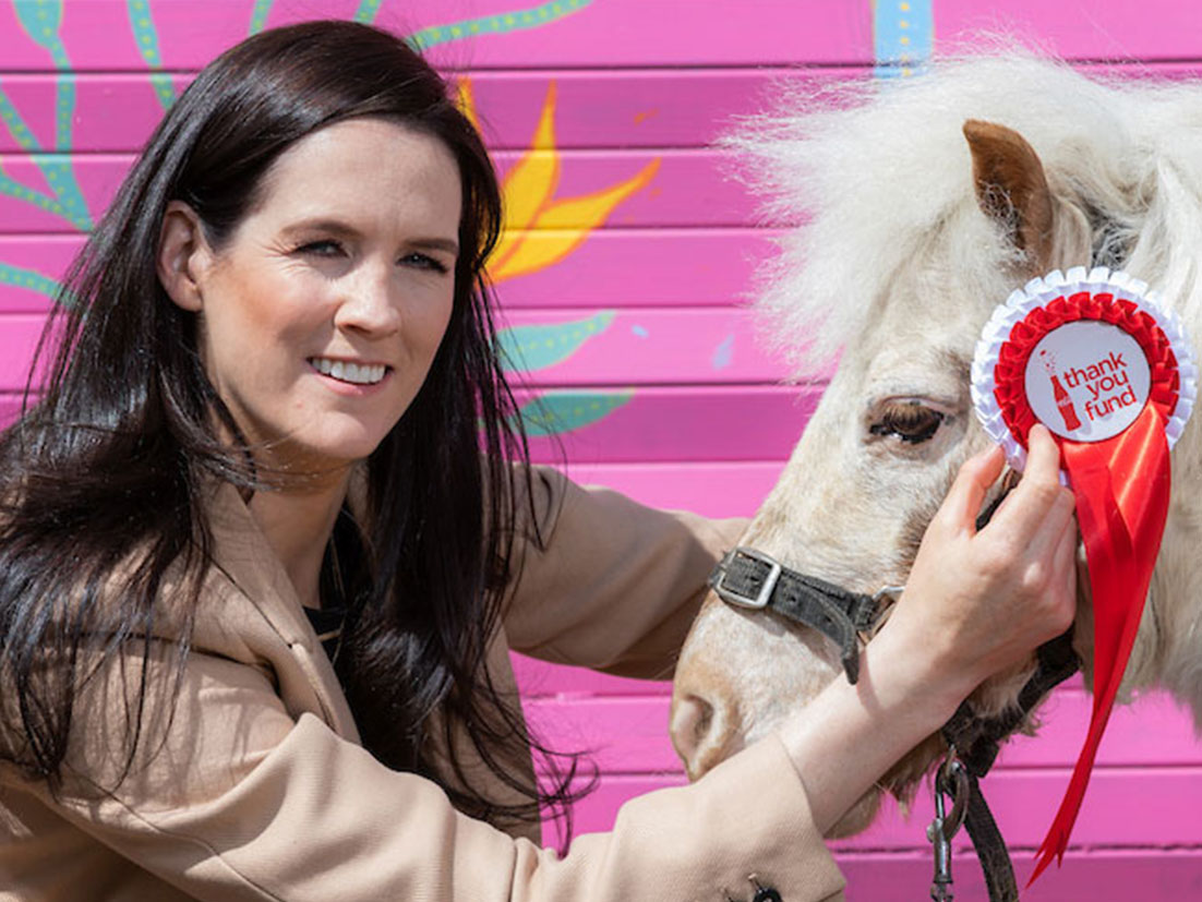 Woman holding a pony