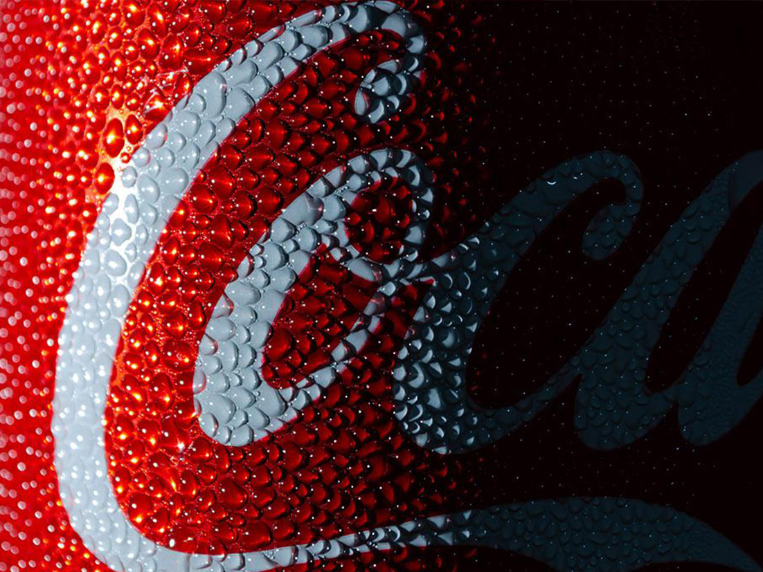 Detail of small droplets outside a Coca-Cola can on a dark background