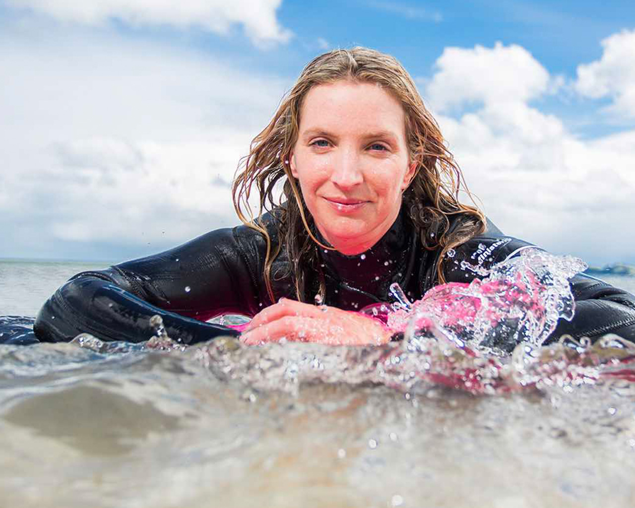 Woman lying in sea water on a sunny day