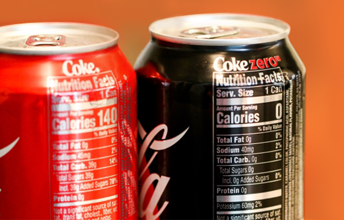 A Coca-cola and Coca-Cola Zero Sugar can side by side