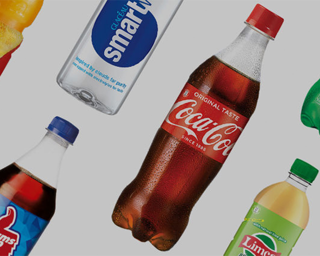 A. selection of sprite, powerade, rani and coca-cola bottles laying flat.