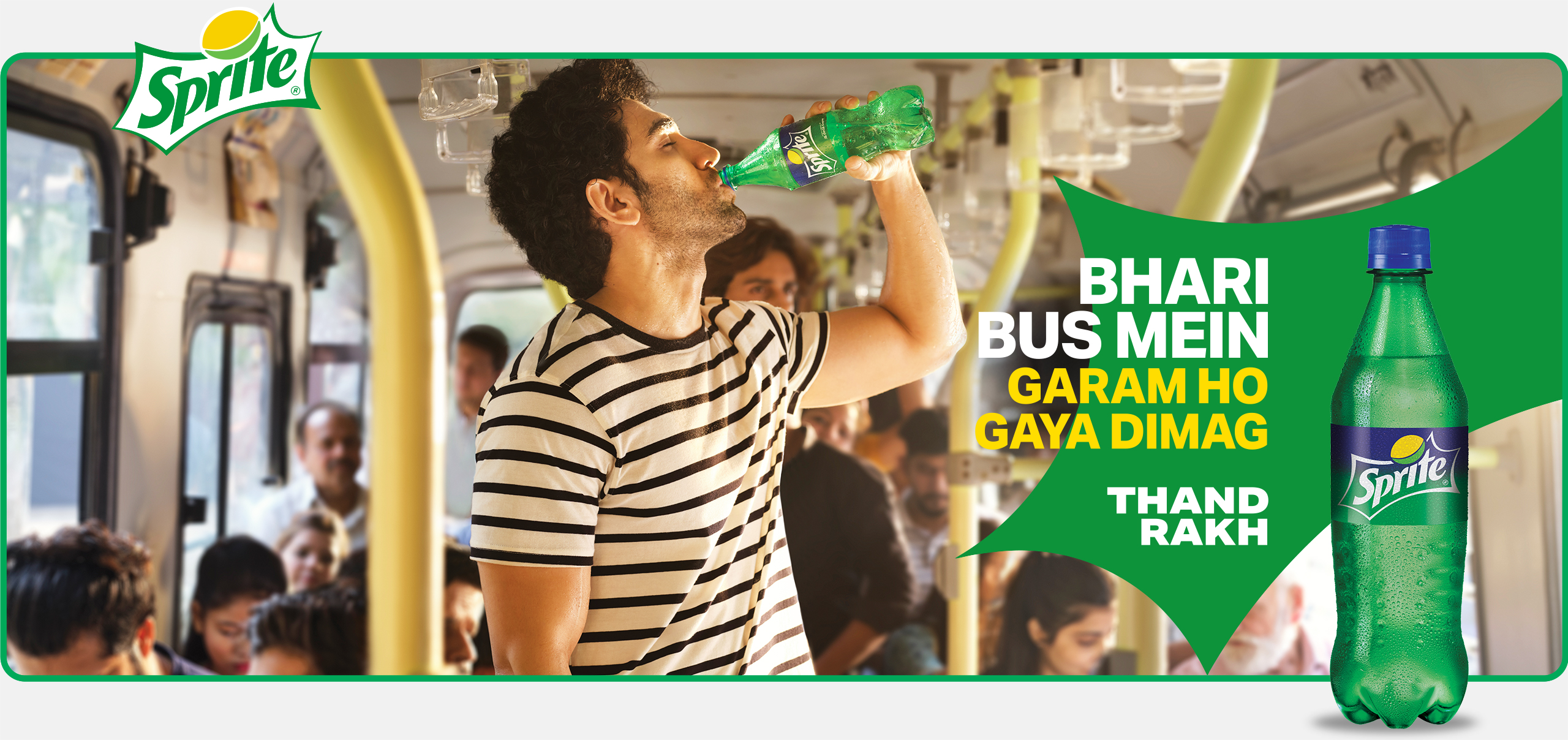 Young man thirstily drinking Sprite on a busy bus with the words: BHARI BUS MEIN. GARAM HO GAYA DIMAG. THAND RAKH. 
