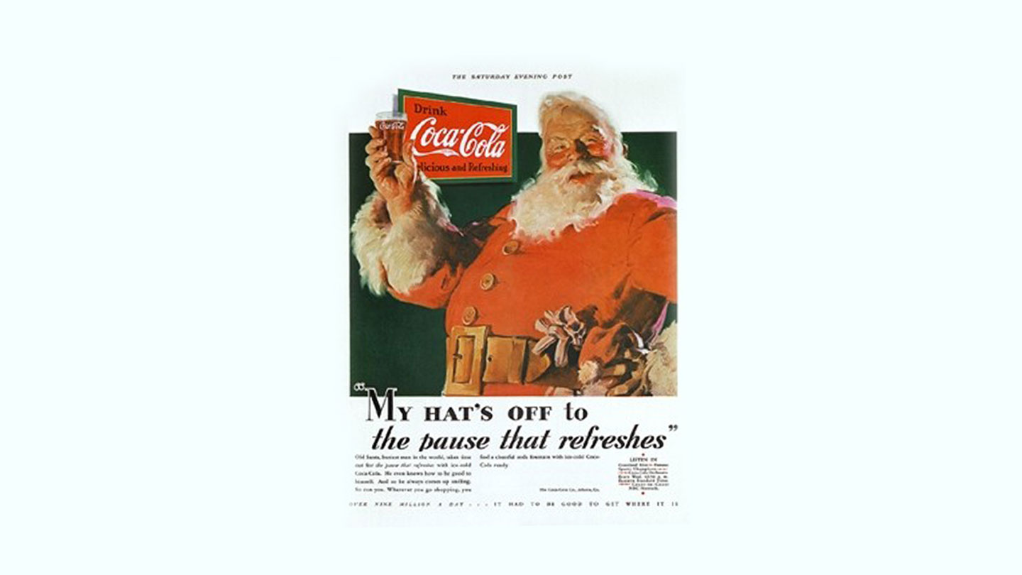 コカ・コーラのグラスを持つサンタクロースが描かれた広告