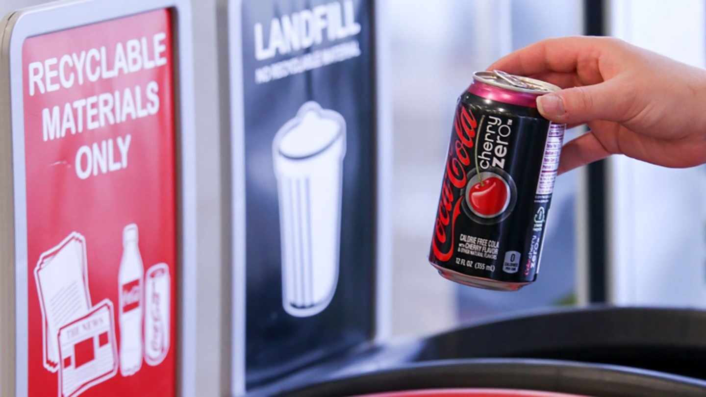 코카-콜라 캔 음료를 재활용 플라스틱 용기에 버리기