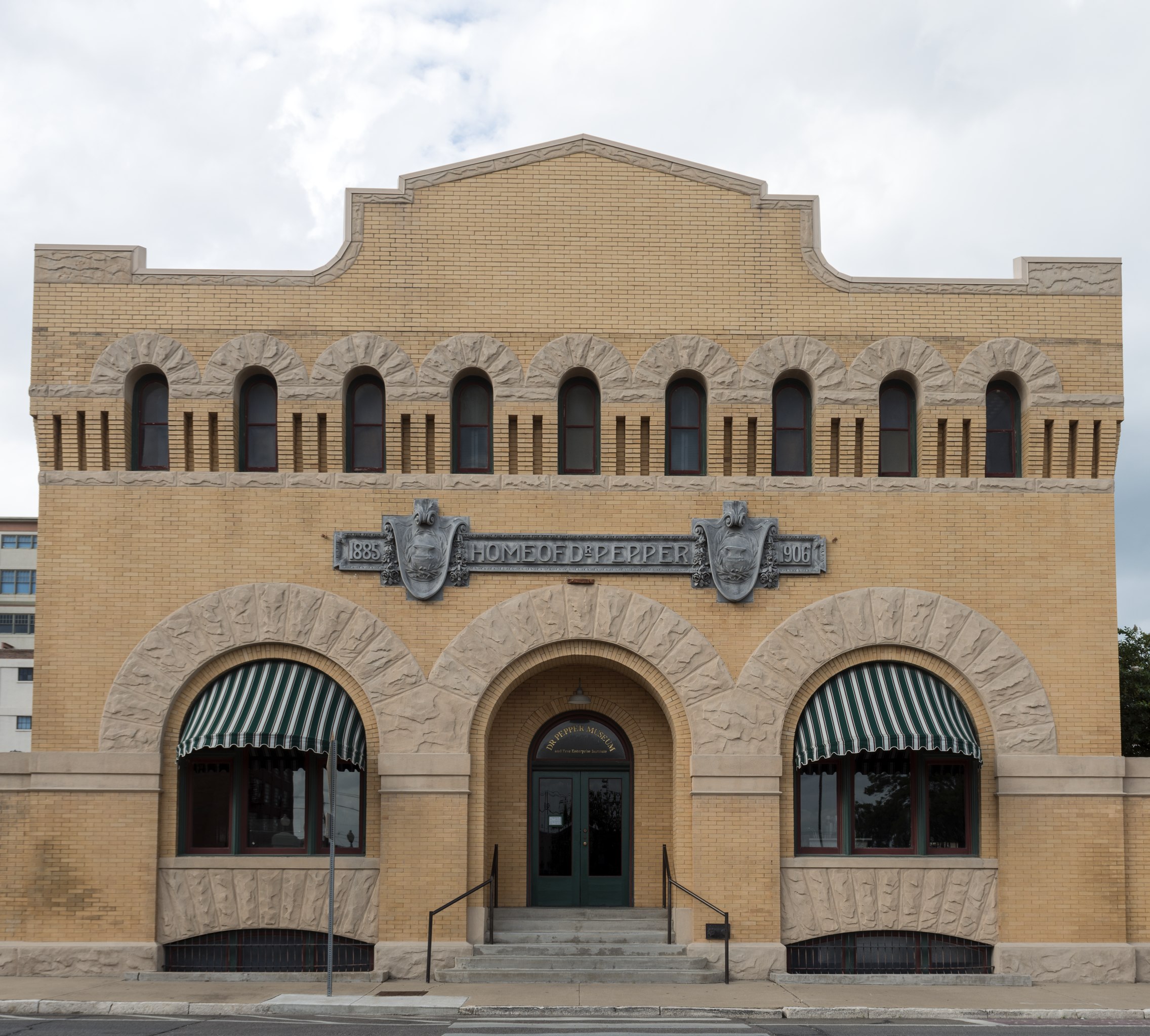 The Dr Pepper Museum in Waco, Texas.  The museum, housed in the 1906 Artesian Manufacturing and Bottling Company building located in downtown Waco, receives the support of Dr Pepper Snapple Group and its affiliated bottlers but is not owned or operated by them. The Dr Pepper Museum was founded in 1988 by the private, nonprofit Dr Pepper Museum & Free Enterprise Institute "to educate and entertain the general public through the collection, preservation, interpretation, and exhibition of objects relevant to the history of the soft-drink industry, and through that example, the free enterprise economic system."   (NOTE TO RESEARCHERS: although the drink's name is often seen spelled with a period, e.g. "Dr. Pepper," it is spelled without one by the company and by the museum.)