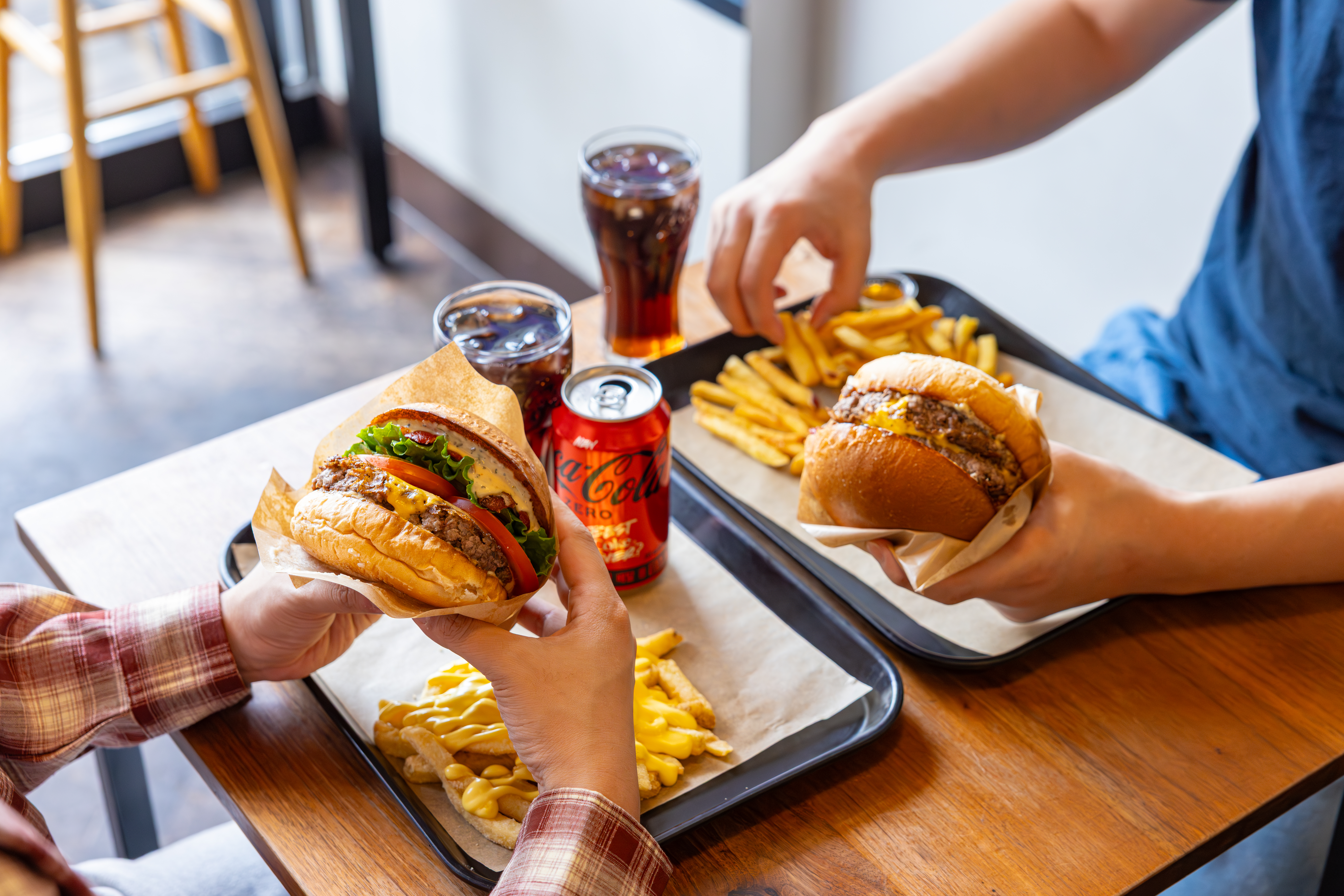 레드리본 맛집 ’래빗홀버거컴퍼니’의 대표메뉴, 클래식 버거 세트와 더더블버거 세트를 코카-콜라 제로와 함께 즐기고 있다.
