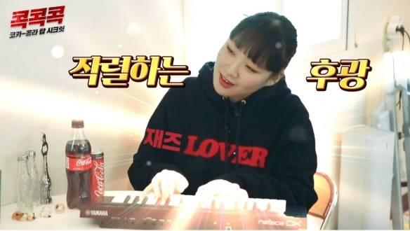 코카-콜라 음료와 함께 키워드를 놀이하는 소녀