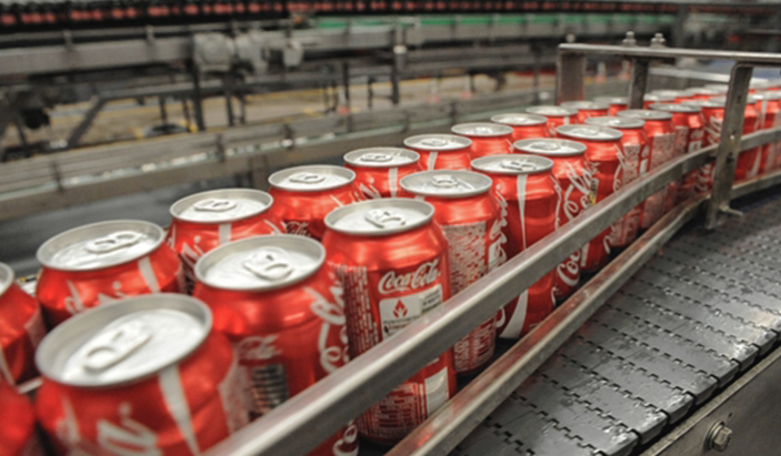 A factory line of coca cola cans.