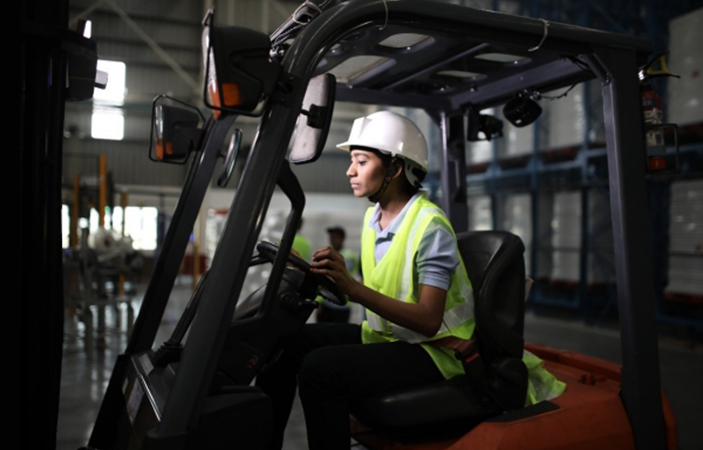 A person driving a forklift.
