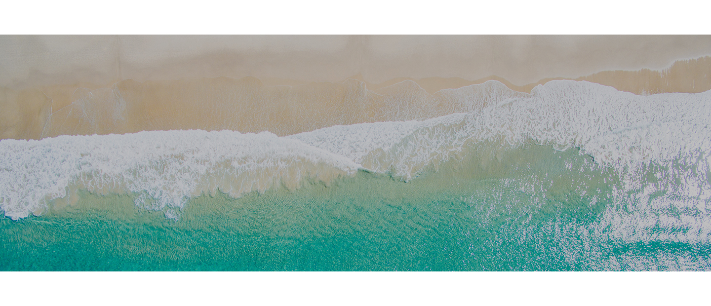 Waves lapping against golden sand