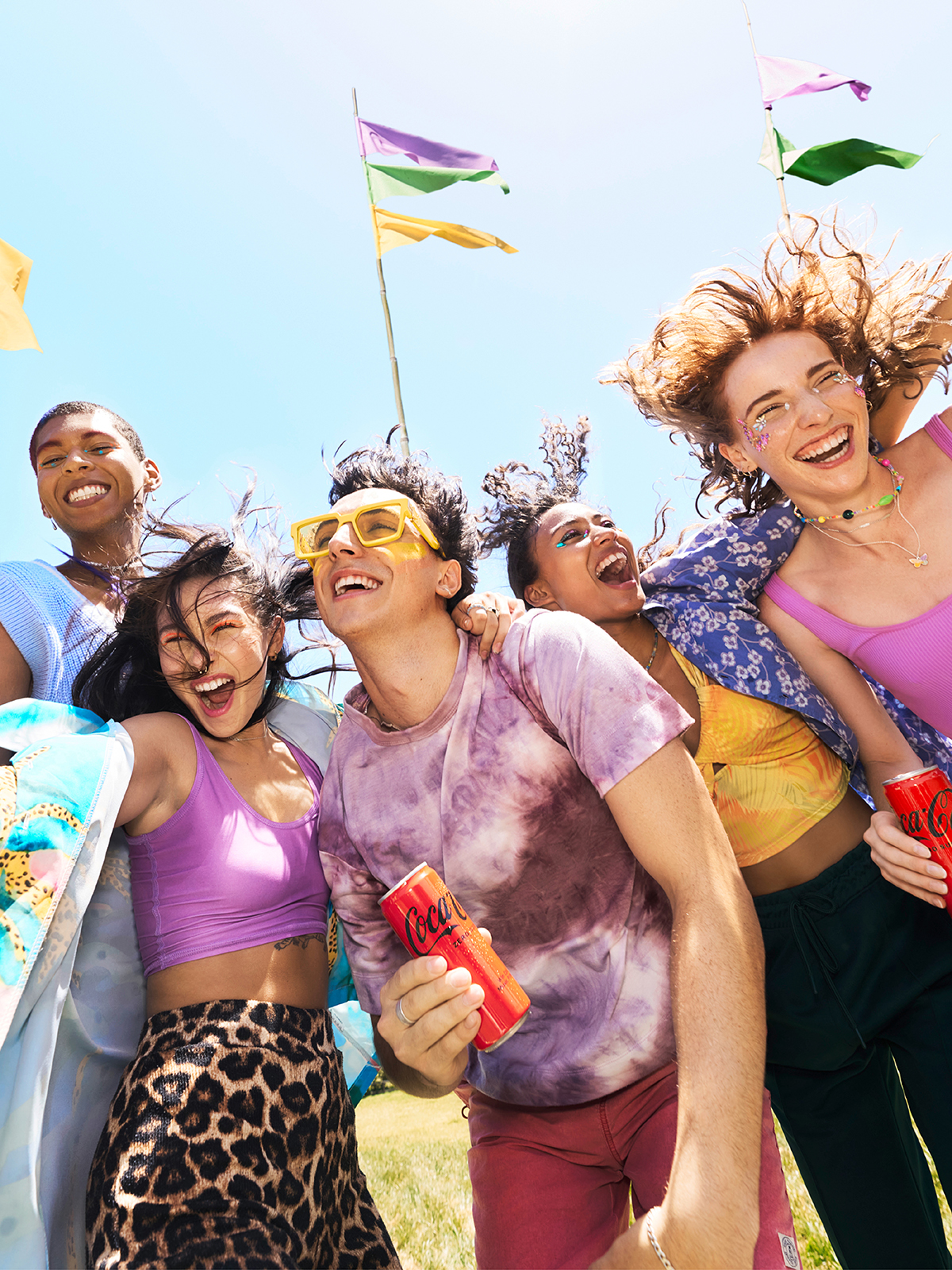 Group of people enjoying a misic festival drinking coca cola