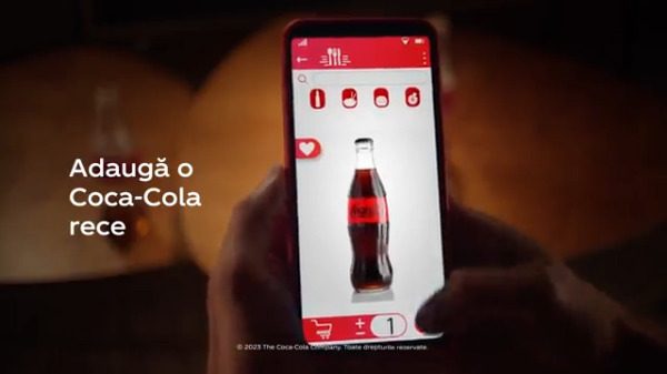 Captură de ecran de telefon cu adăugarea unei sticle de Coca-Cola în coșul de cumpărături
