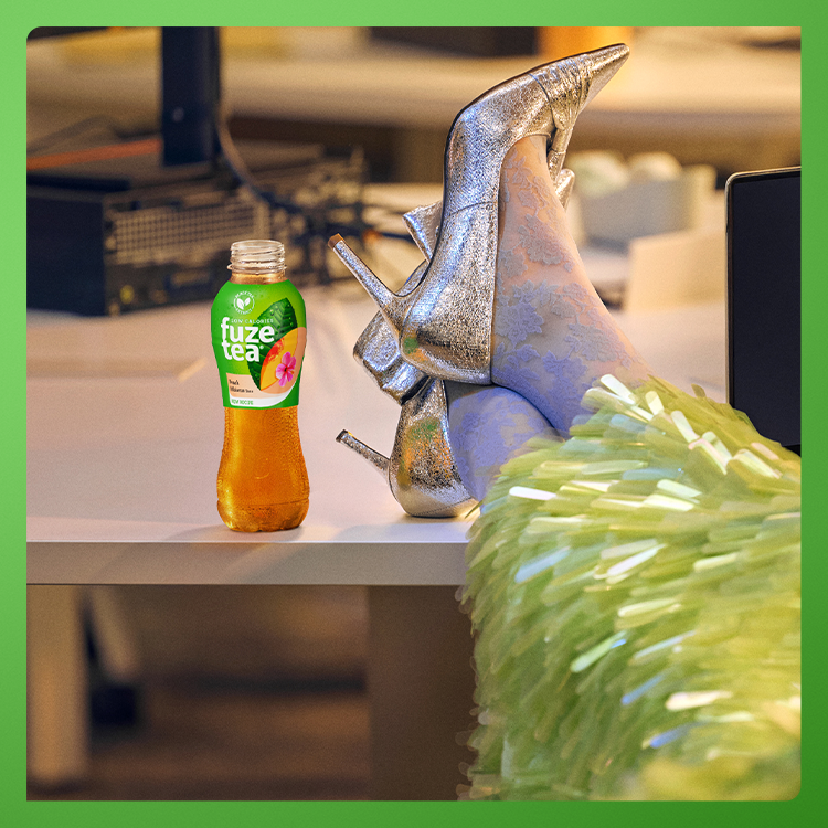 Putting high-heeled feet up next to bottle of fuze tea