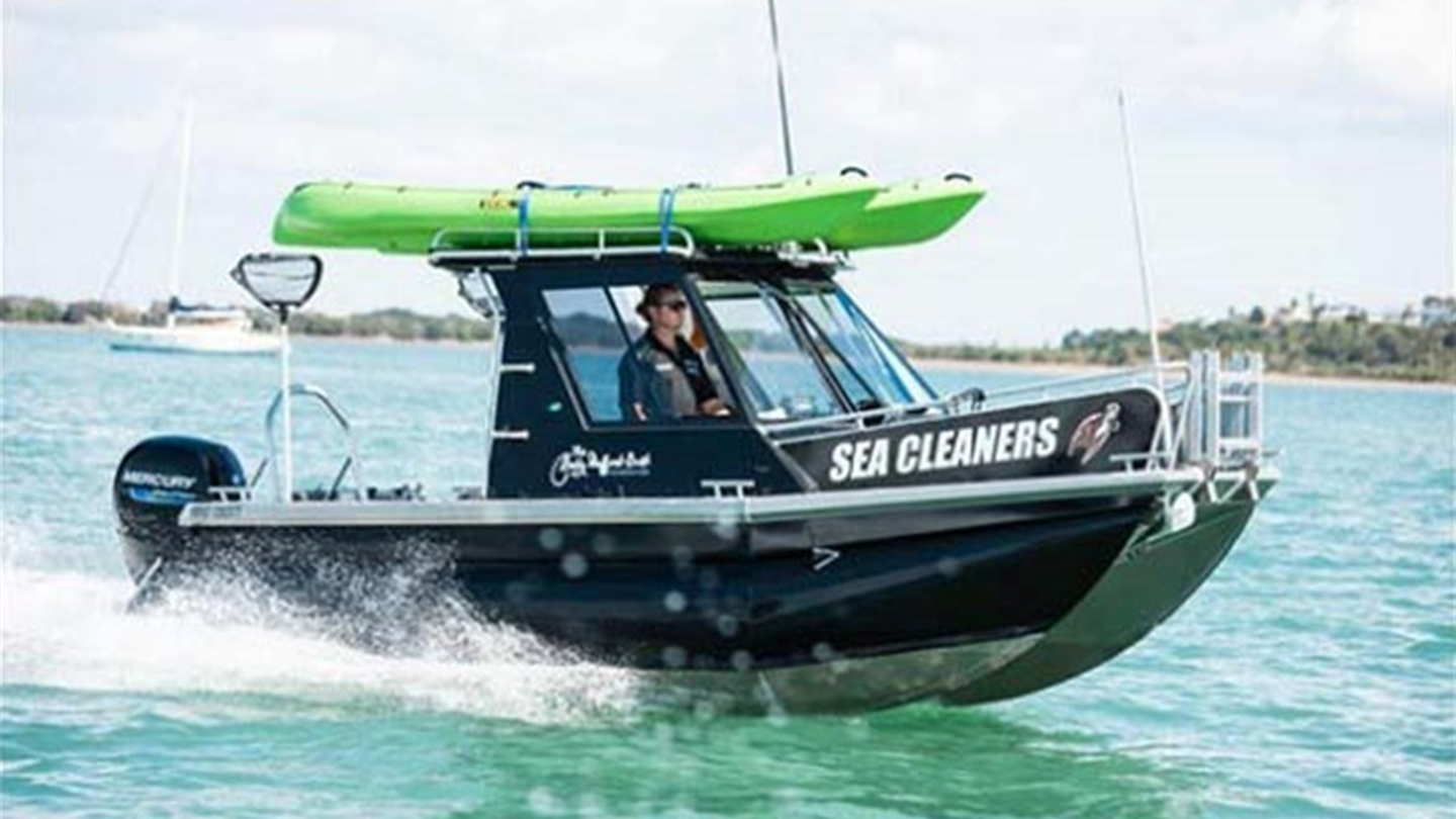 A Sea Cleaners boat crossing a river