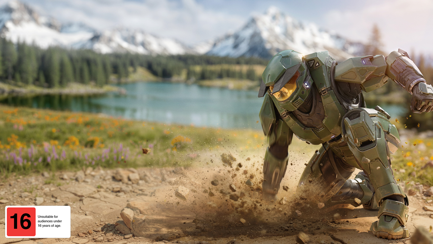 An armored soldier lands with a crash in front of a lake and mountain landscape.