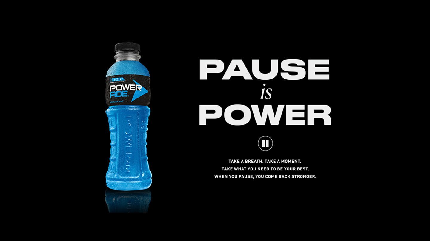 Powerade Mountain Blast bottle in a black background with the phrase "Pause is power".