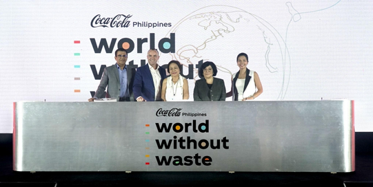 A group of people behind a metallic balcony during a World Without Waste press release conference