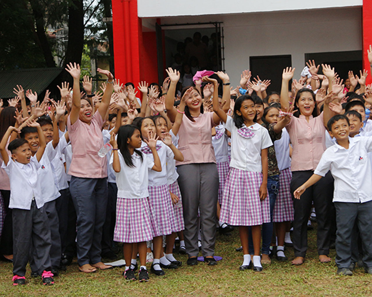 A large group of children waving