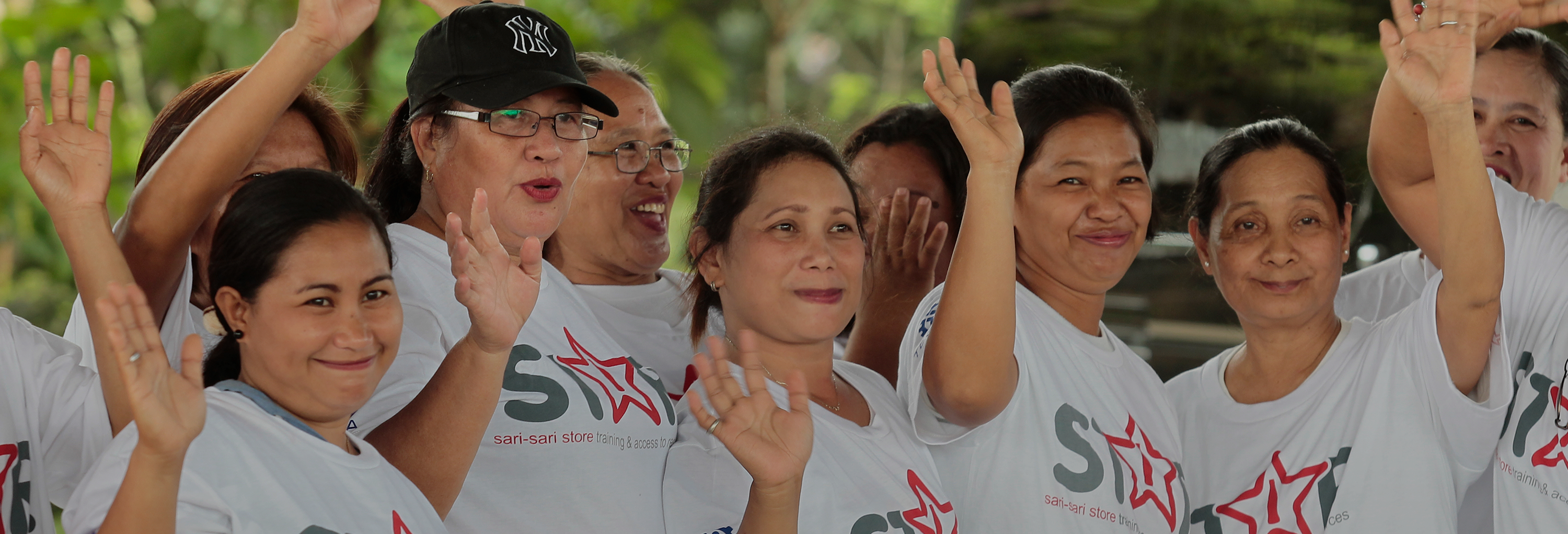Group of women with STAR Project T-shirts waving