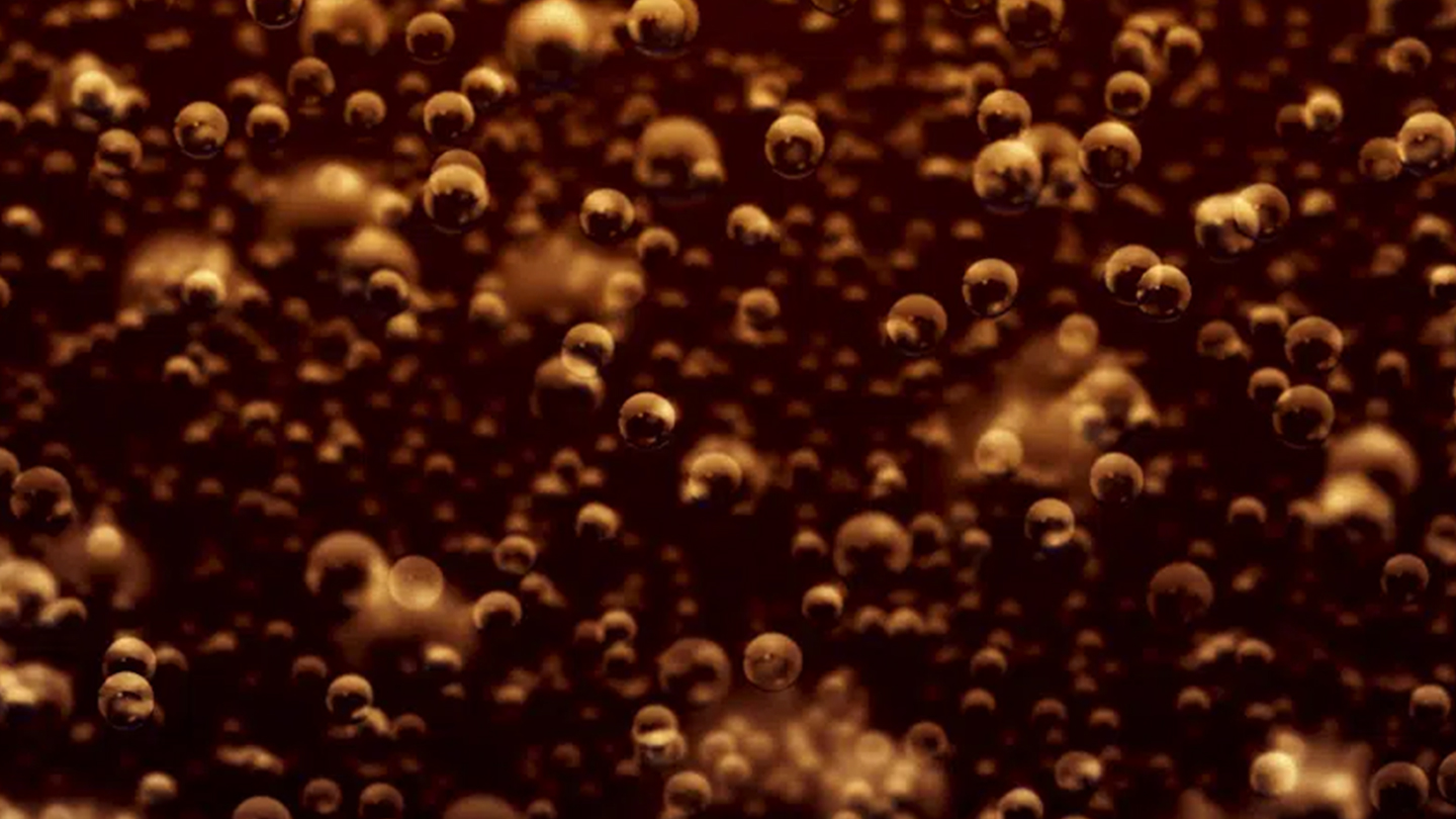 Detail of sparkling bubbles inside a Coca-Cola drink