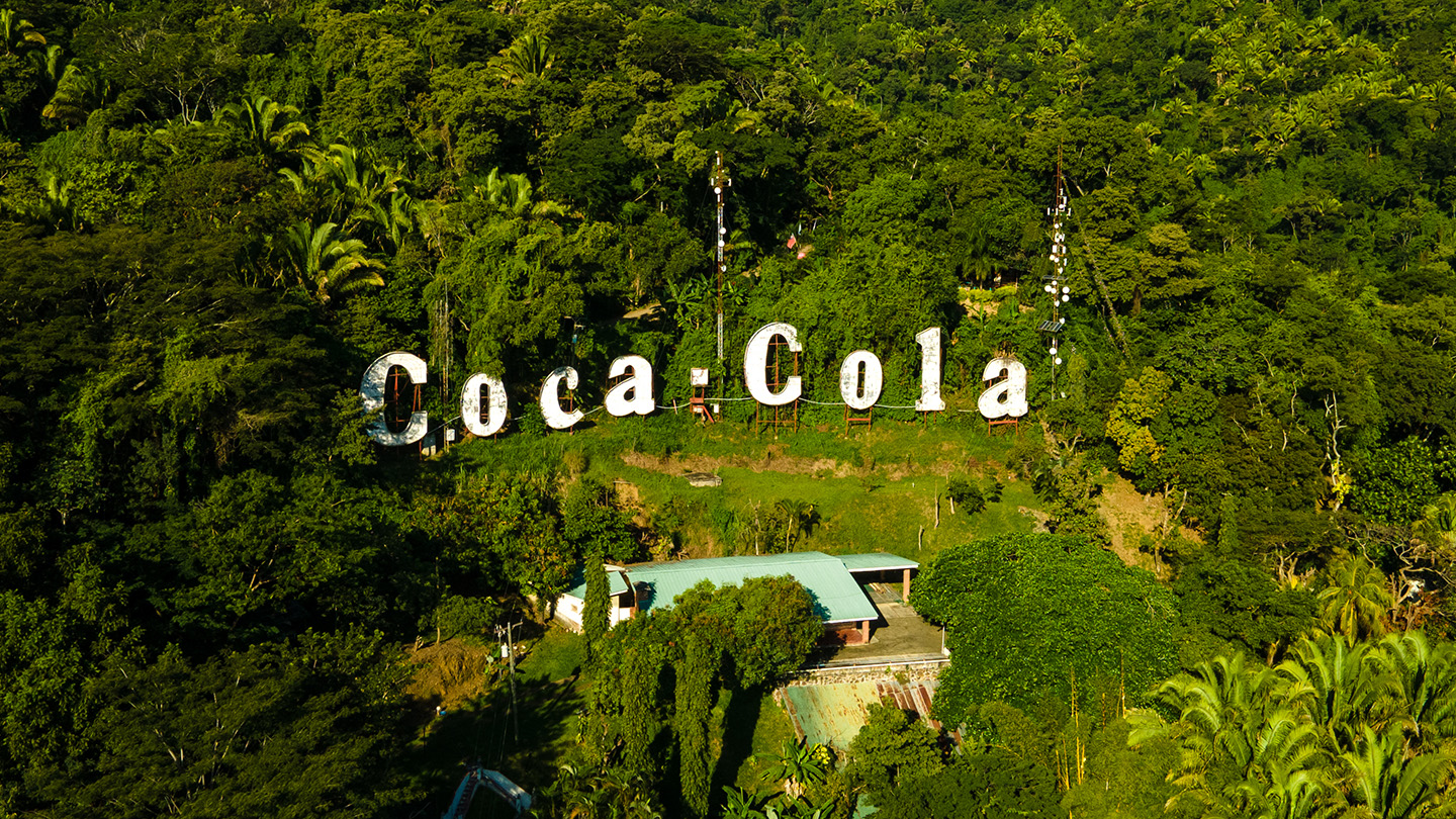 Aerial view of a Coca-Cola sign in a forest