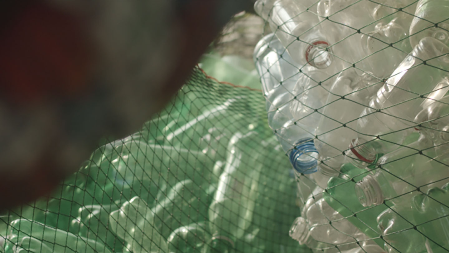 A lot of empty plastic bottles inside a net