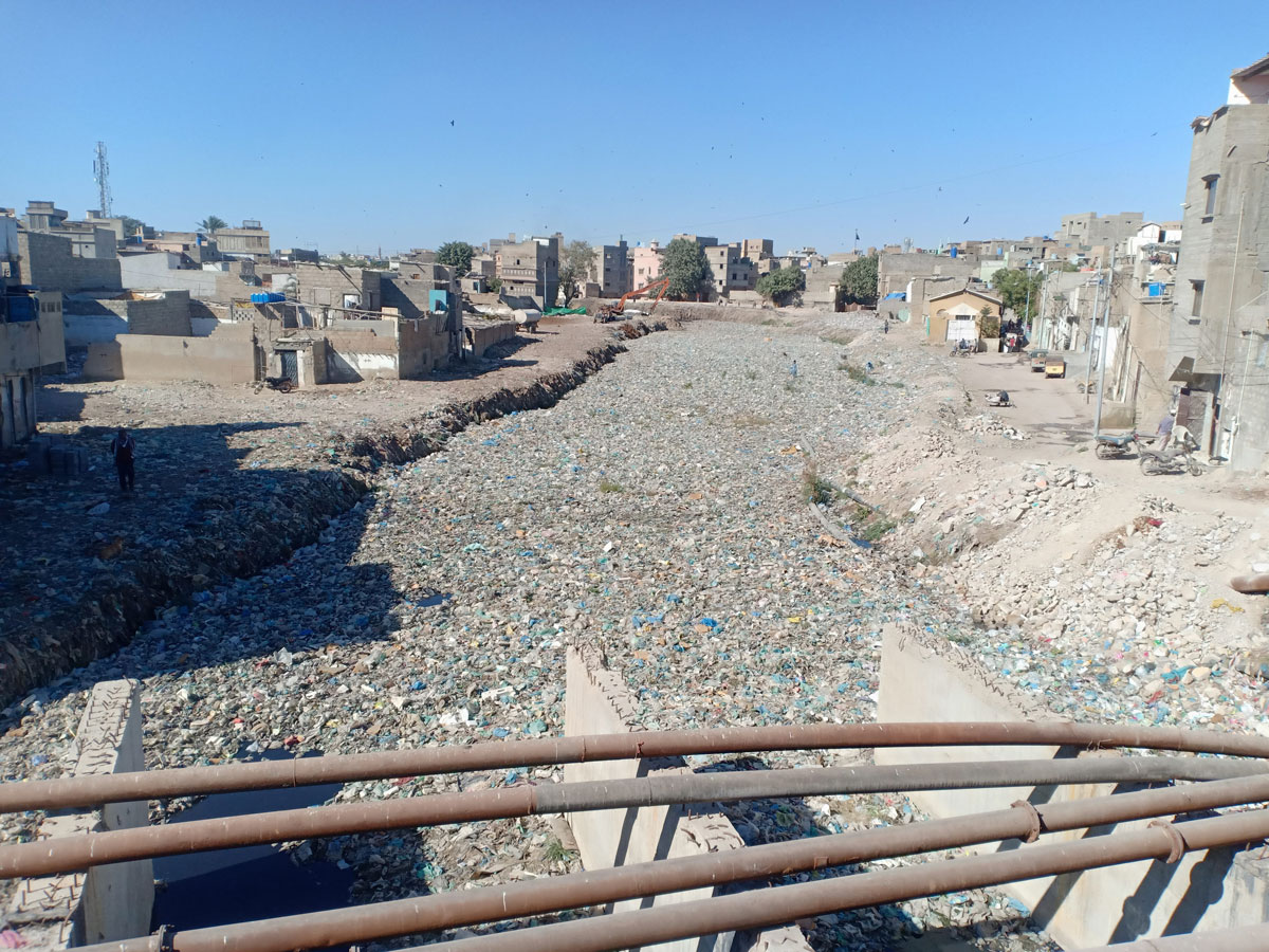 A place with houses and a river covered in residues