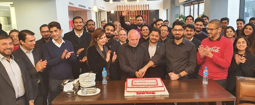 A group of people at The Coca-Cola Company birthday celebration