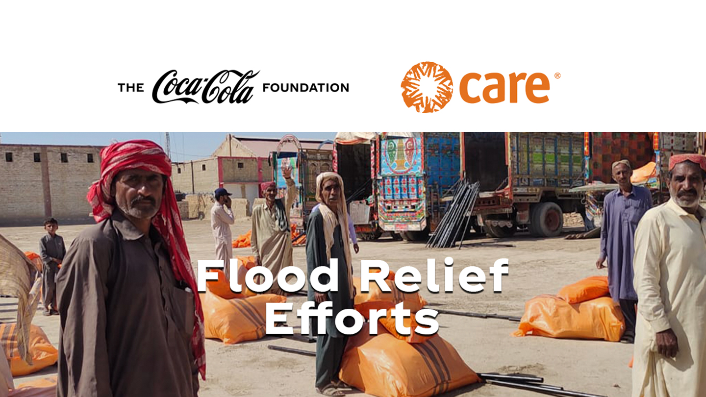 A group of people unloading supplies from trucks