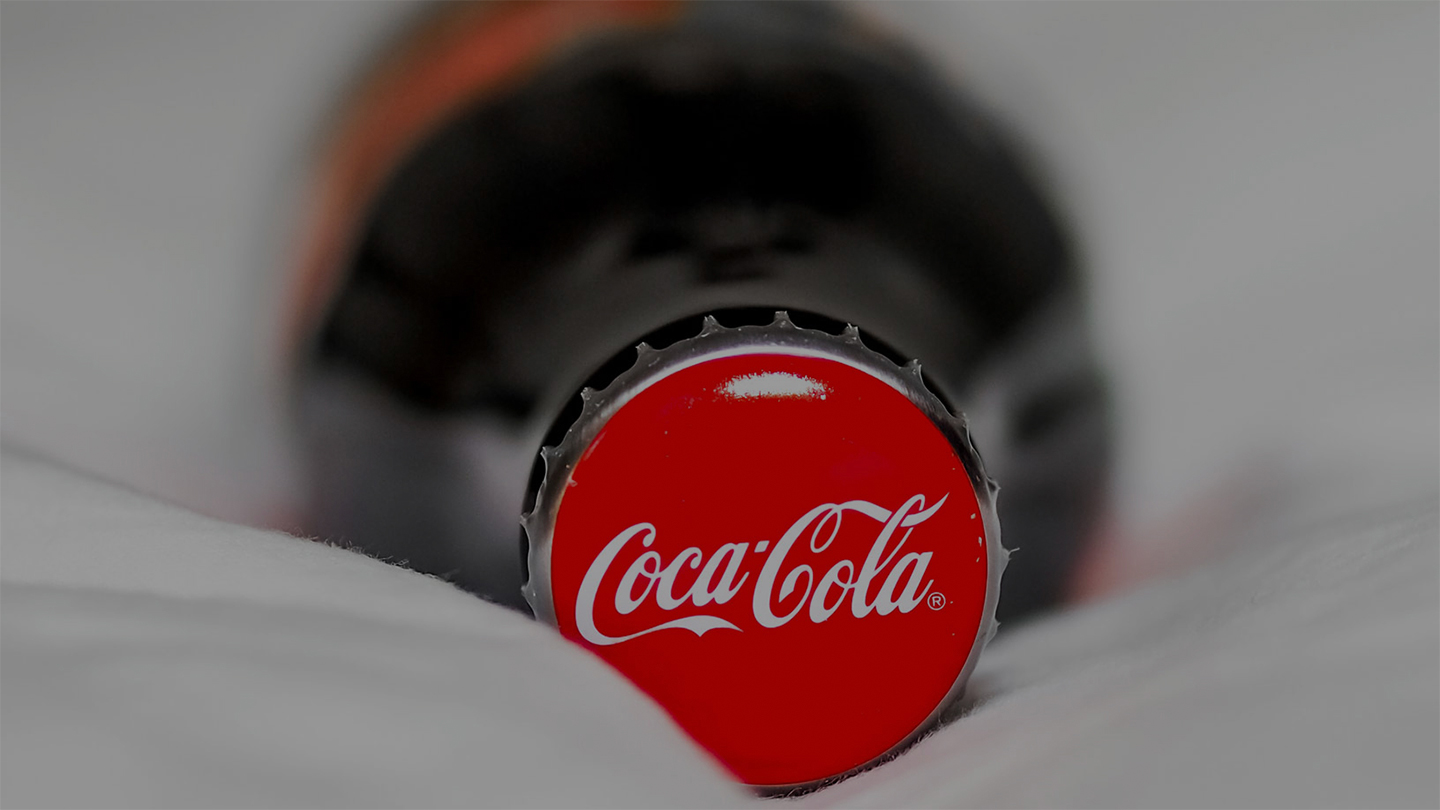 A Coca-Cola can lying on a surface