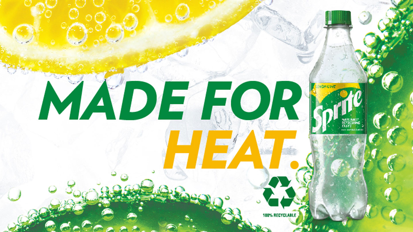 A Sprite bottle and the phrase 'Made for heat' on a background with big slices of lemon and orange