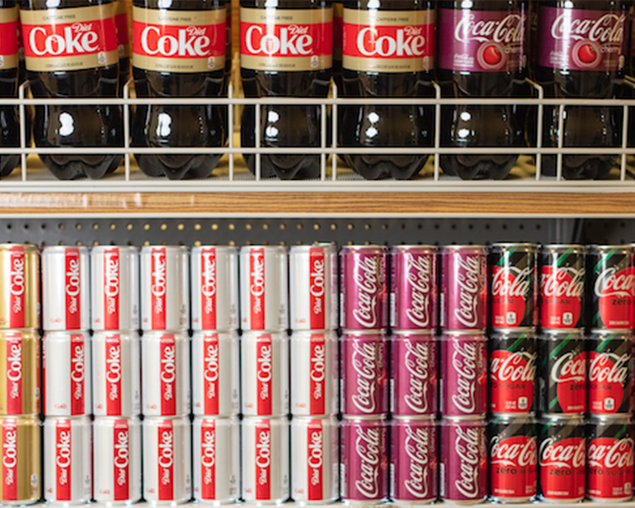Shelf showing a variety of Coca-Cola products and packagings