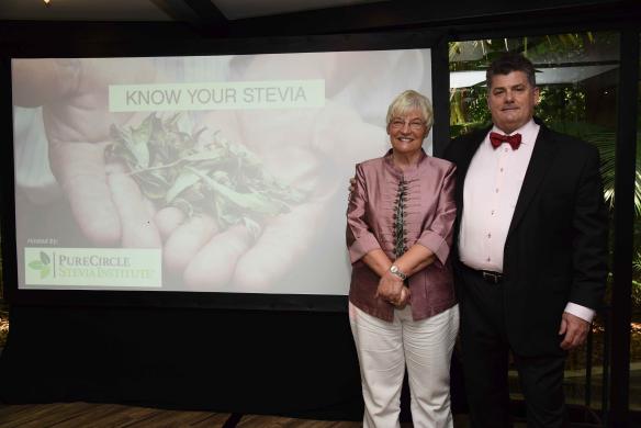 Dr. Margaret Ashwell and Mr. Gary Juncosa pose in front of a Know Your Stevia banner