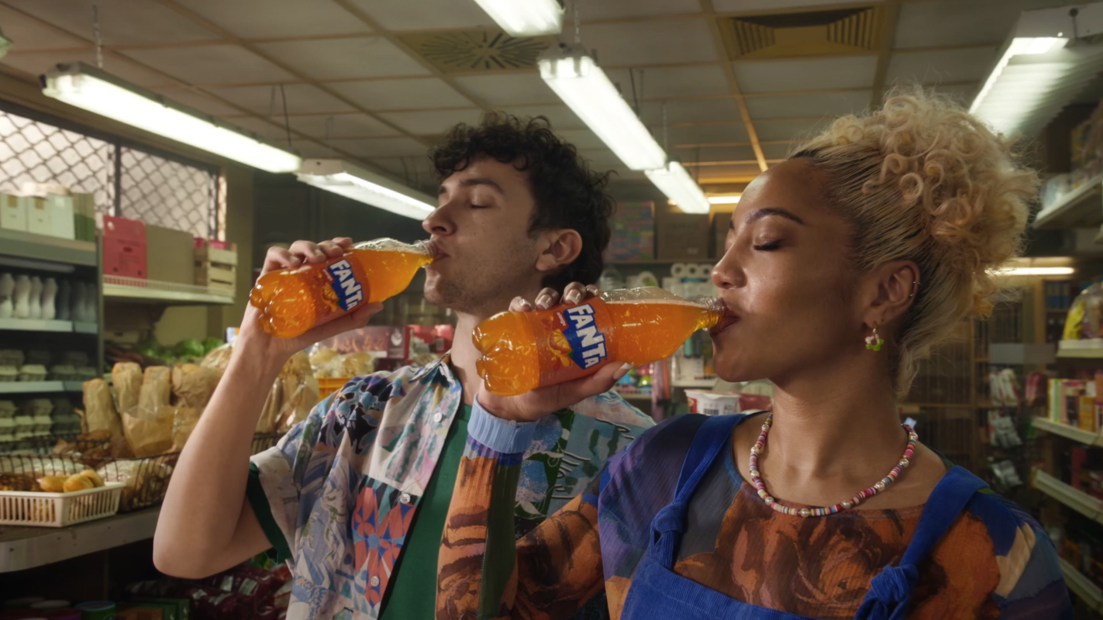 two people drinking fanta