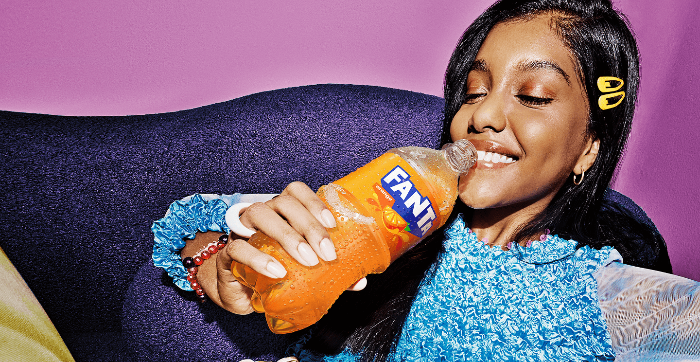 Woman drinking Fanta Orange soda