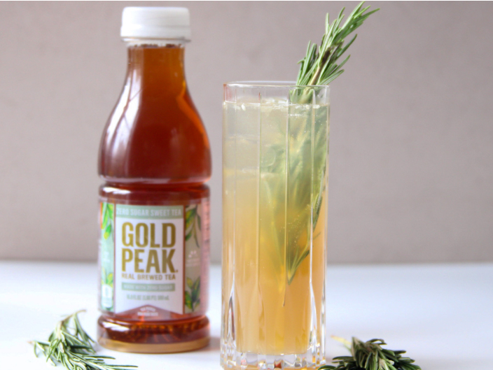 gold peak bottle next to orange mocktail