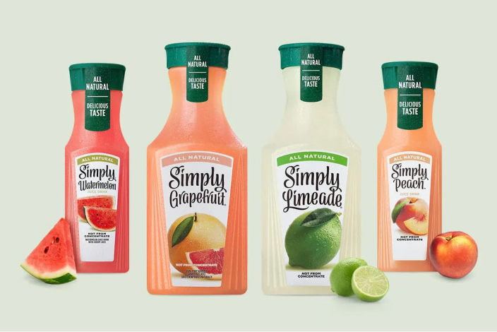 Four containers of different Simply flavors with fruit in the foreground