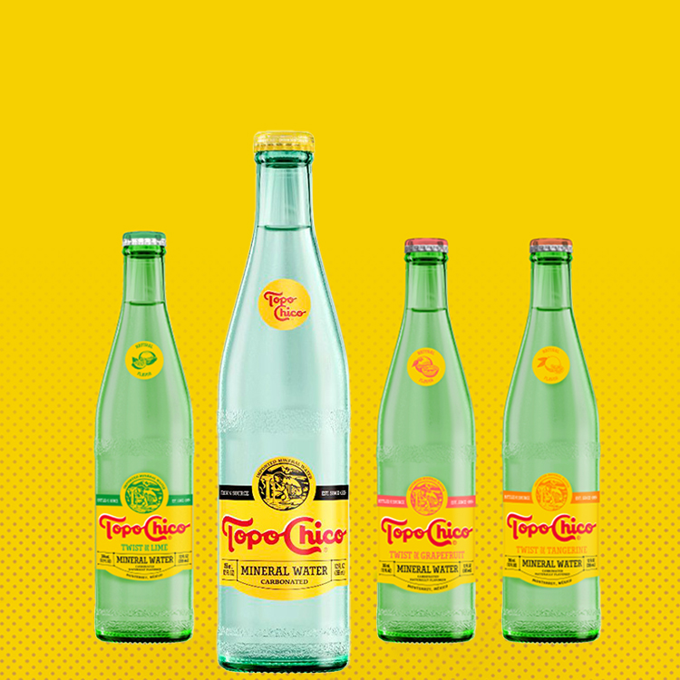 Four Topo Chico bottles in a yellow background